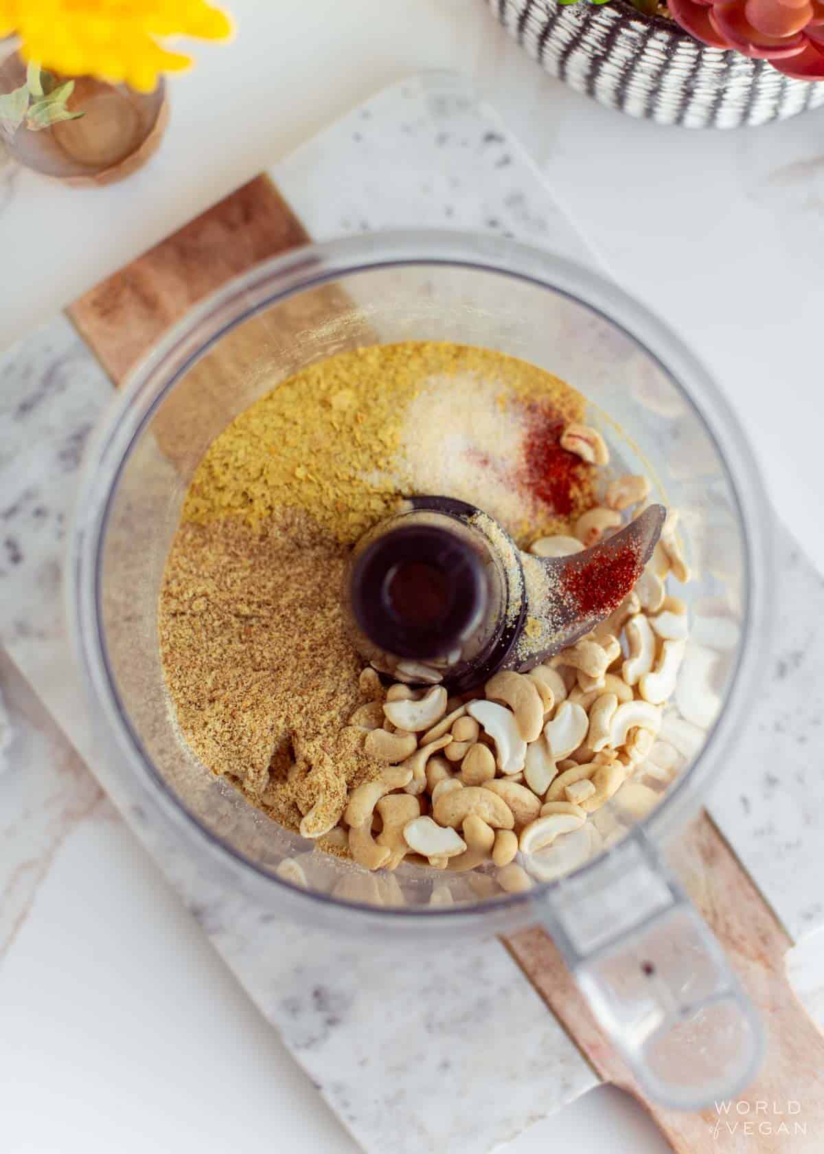 Homemade vegan parmesan cheese ingredients in a food processor.