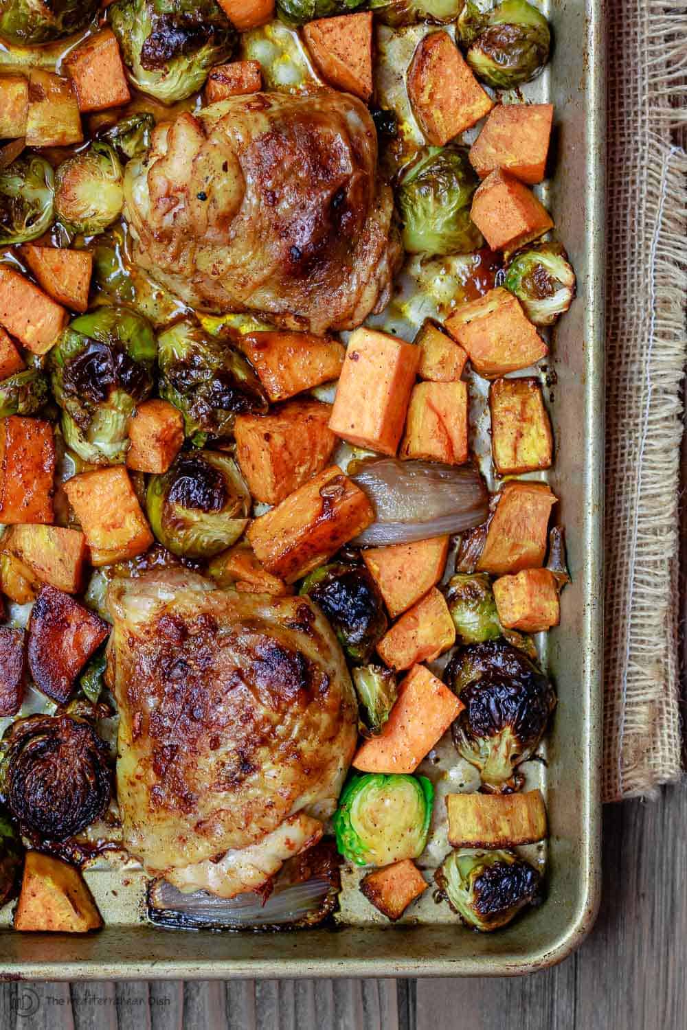 Sheet Pan Paprika Chicken and Vegetables | The Mediterranean Dish. This paprika chicken is never a hard sell at my house! Easy, flavor-packed sheet pan chicken with brussels sprouts and sweet potatoes. A comforting and healthy recipe for any night of the week! See the full recipe on TheMediterraneanDish.com. #mediterraneanrecipe #mediterraneandiet #paprikachicken #chicken #sheetpandinners #chickendinner #sheetpanchicken