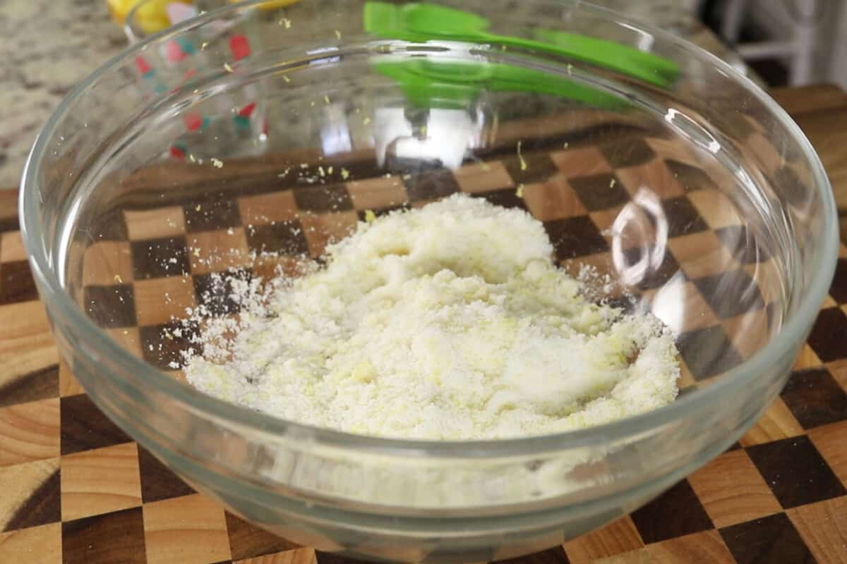 fresh lemon zest and sugar in glass bowl for lemon loaf