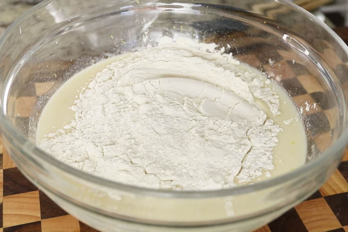 making batter for glazed vegan lemon loaf in large glass bowl