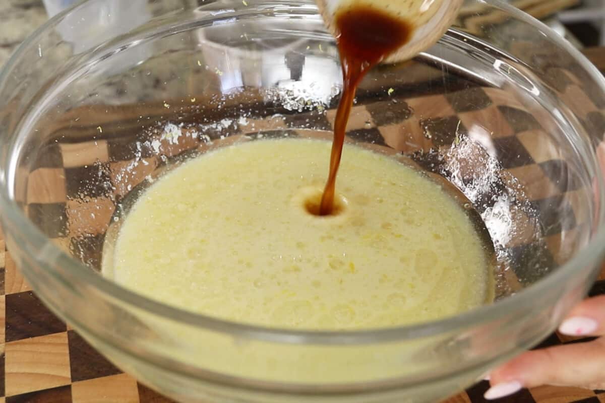 adding vanilla ectract to large glass bowl for lemon loaf batter