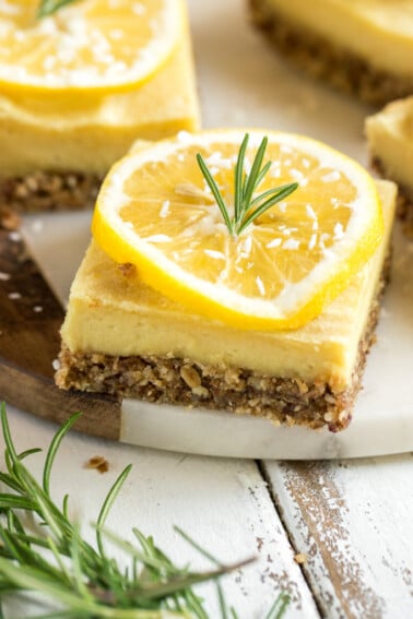 With the perfect balance of tart and sweet, these creamy lemon bars are a must try dessert. They are of course 100% vegan, and also 100% delicious. Plus, they are naturally-sweetened and gluten-free--say whaaaat! #vegan #dessert #lemon #rosemary #mindblowing #sweet #refinedsugarfree #naturallysweetened #medjooldates #coconutoil #unique #musttry #veganized #eggfree #dairyfree #snack #lemonbars