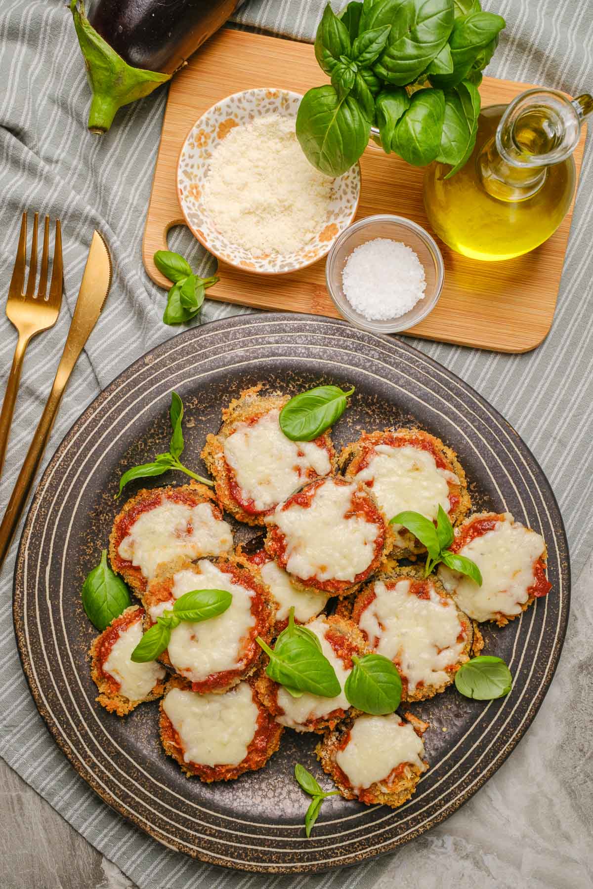 A plate of vegan eggplant parmesan with marinara sauce and vegan mozzarella.