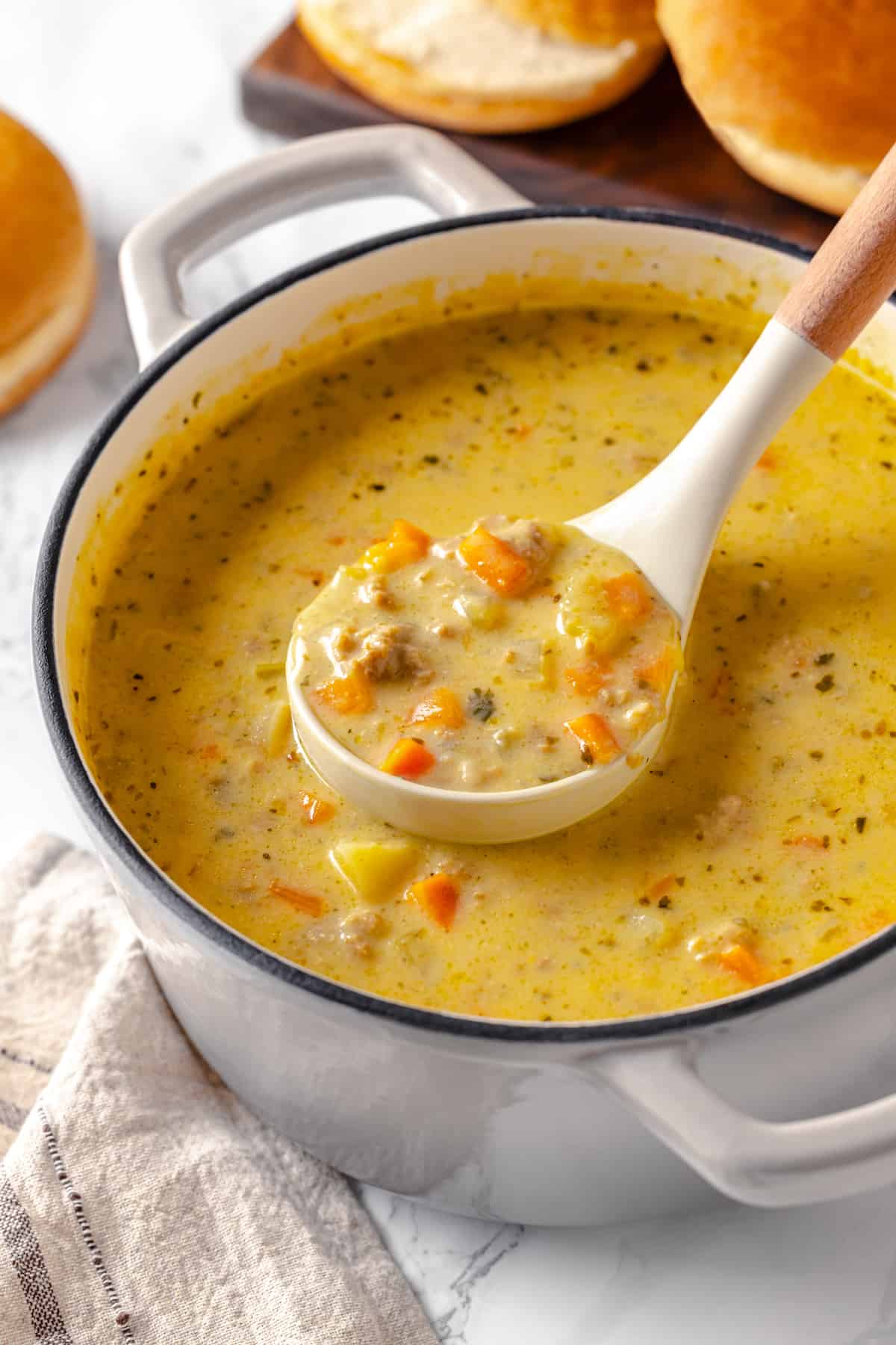 Ladle of cheeseburger soup in pot