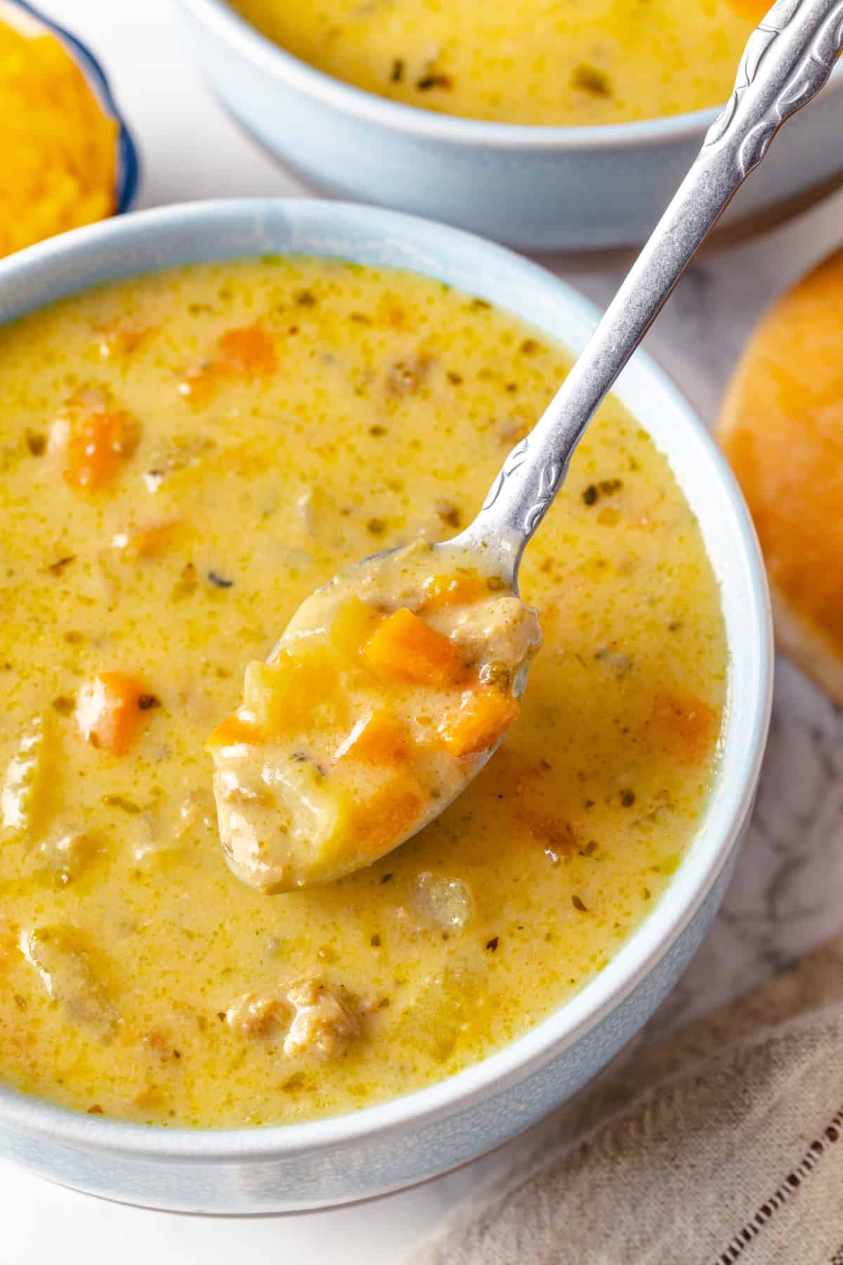 Spoonful of cheeseburger soup in bowl