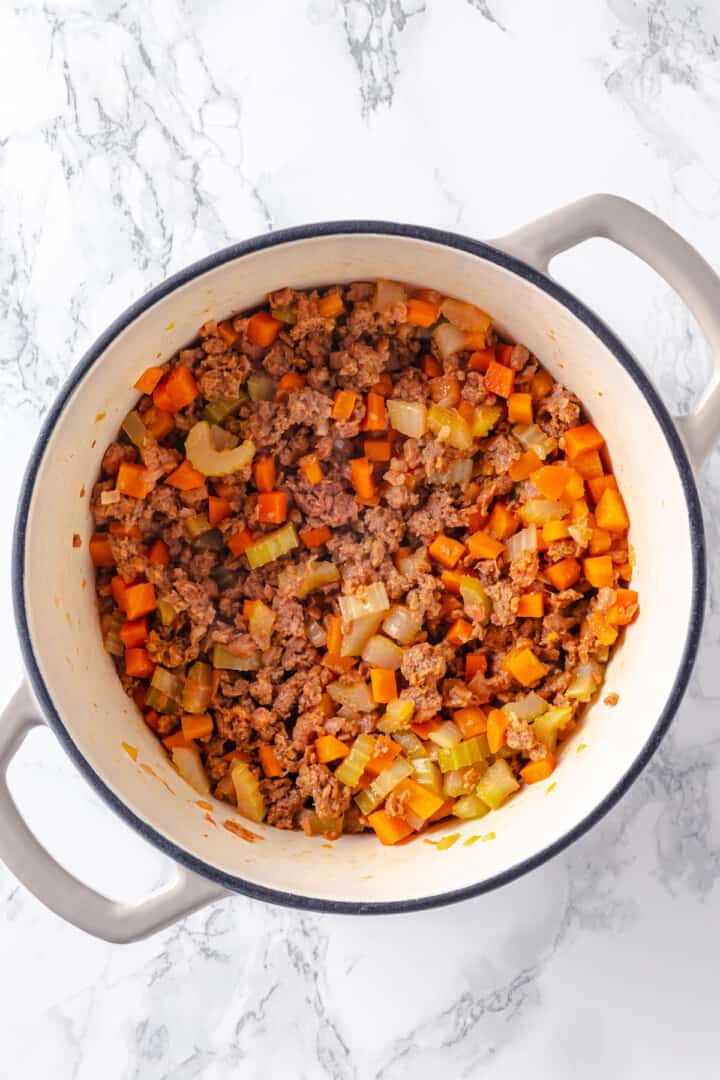 Overhead view of cheeseburger soup before adding potatoes