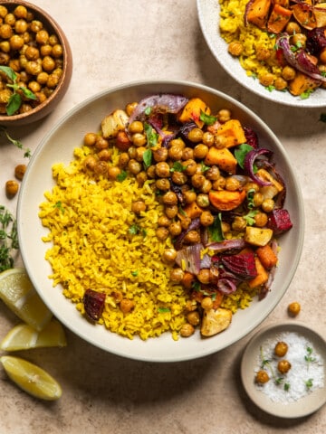 root vegetables, spiced chickpeas, and lemon rice in a bowl on a table.