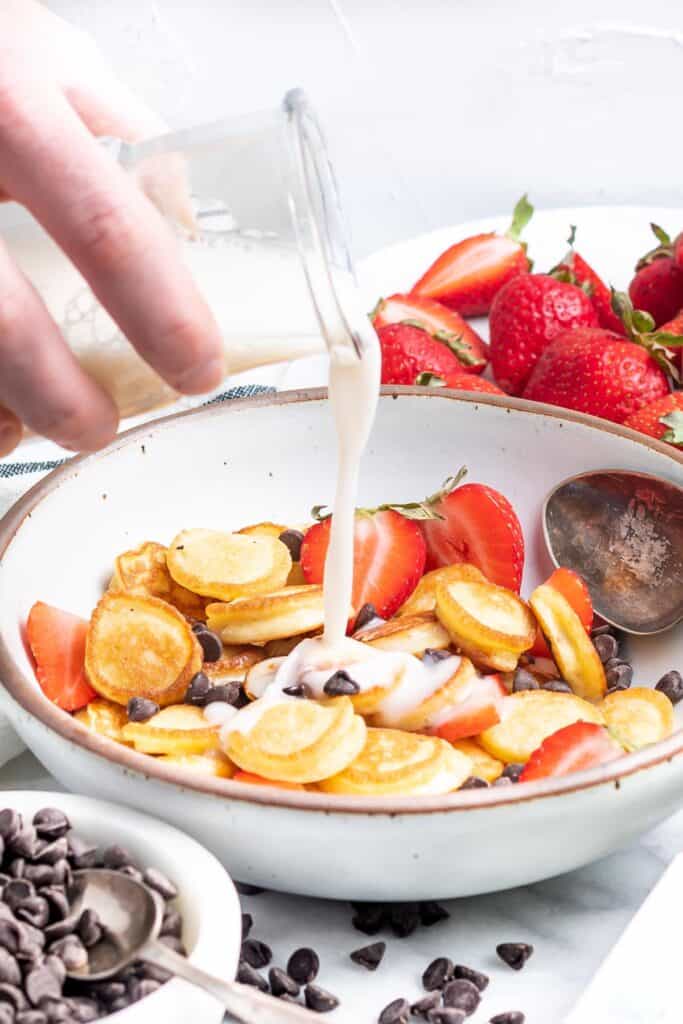 Keto Pancake Cereal in a bowl topped with chocolate chips and strawberries