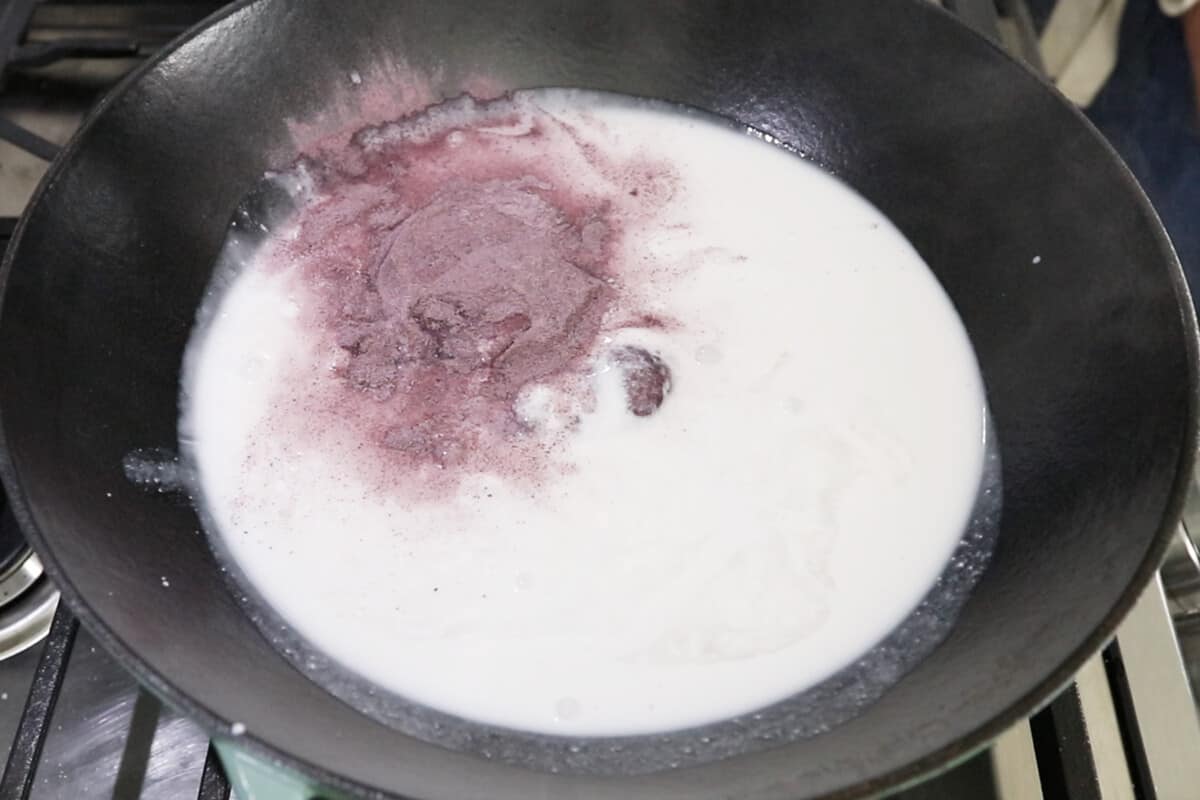 adding ube powder to coconut ilk