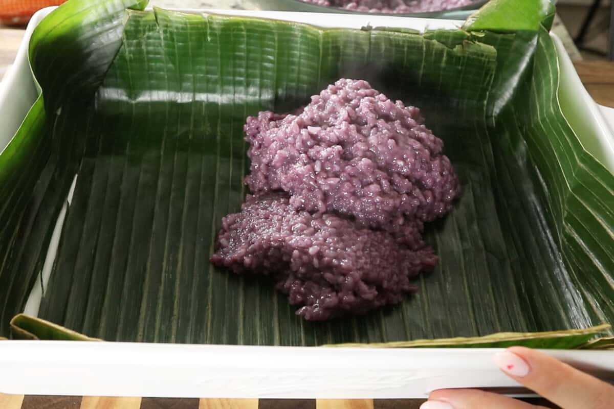 scooping biko into banana leaf lined tray