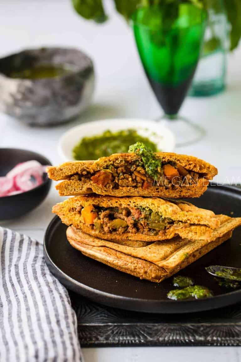 Savoury beef mince in a toasted sandwich on a plate.