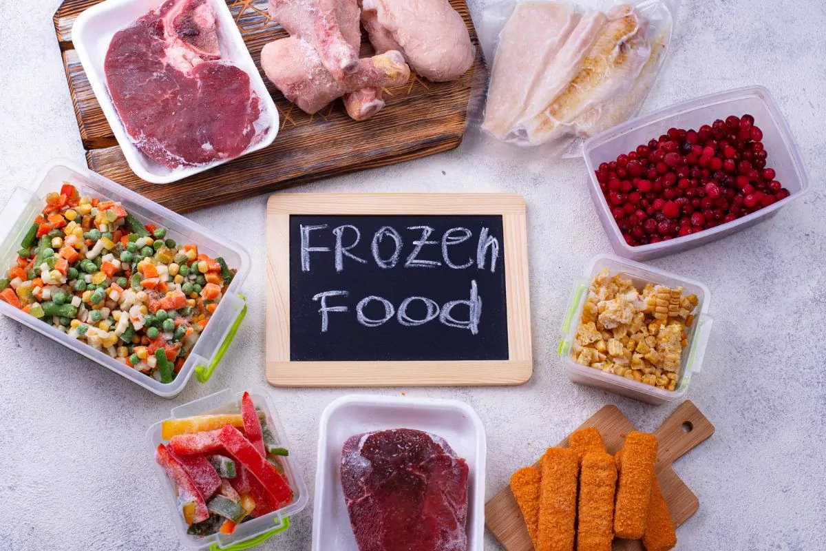 Frozen food including meats, veggies and fruits on different airtight containers.