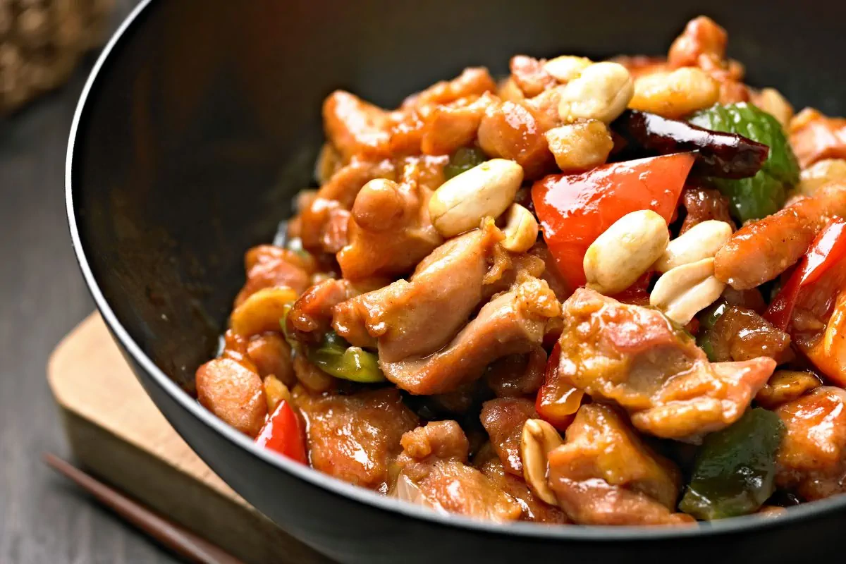 Kung Pao Chicken with bell peppers and peanuts in a bowl.